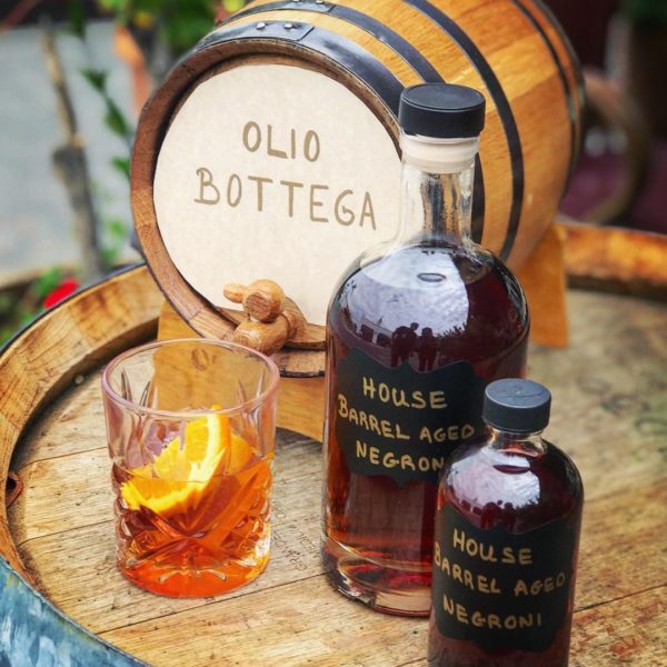 At Olio Bottega, we barrel age this popular Italian cocktail— made with gin, vermouth rosso, and Campari— in our oak barrels for 3 months, bringing out a more complex, smoky flavor.